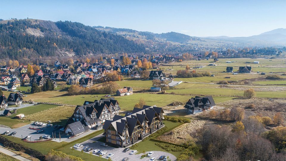 Aerial view visualization showcasing a mountain resort hospitality architecture designed in a mountain chalet style.